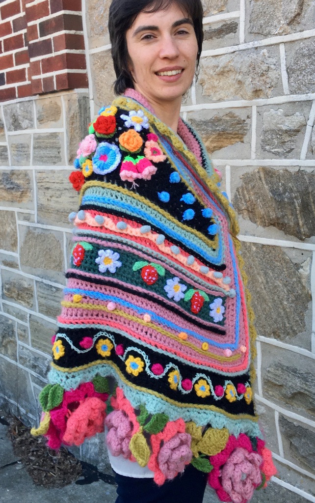 Modeled crocheted shawl showing embellishments on right shoulder