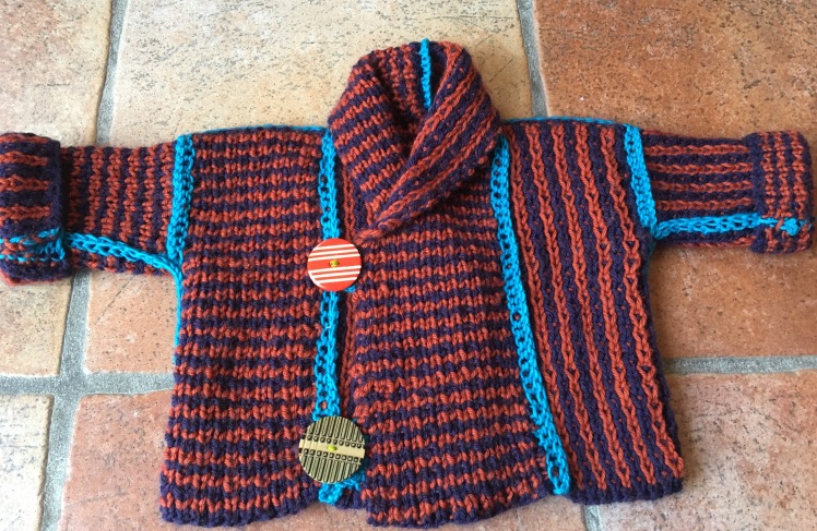 Knitted baby jacket with two-sided stitch pattern