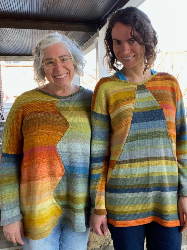 Two similar machine-knit sweaters knitted in plant-dyed yarn with shaped panels, one with triangular panels and the other with zigzag panels